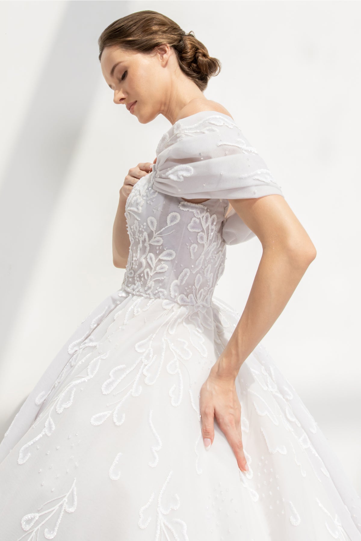 White tulle gown in off-shoulder and scroll embroidery